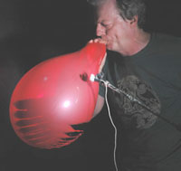 Man blowing up a balloon