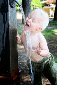 Child drinking water from fountain